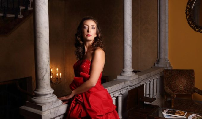 singer with a red dress posing in a villa