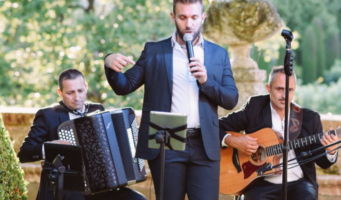 Italian folk trio performing live in a garden